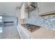 Kitchen featuring stainless steel appliances, light countertops, and decorative backsplash at 1038 Delbrook Ave, Henderson, NV 89012