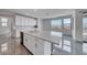 Bright kitchen with stainless steel appliances, island seating, and large windows at 1038 Delbrook Ave, Henderson, NV 89012