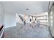 Open-concept living area with tile flooring, modern staircase, and sliding glass doors to bring in natural light at 1038 Delbrook Ave, Henderson, NV 89012