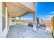 The covered patio features a modern hot tub and beautiful desert views beyond the fenced backyard at 1038 Delbrook Ave, Henderson, NV 89012