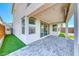 This covered patio has sliding glass doors leading to the interior, and attractive synthetic grass and paved patio at 1038 Delbrook Ave, Henderson, NV 89012