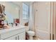 Clean bathroom with a white vanity, toilet, shower and tub combination at 11912 Skyline Arch Ct, Las Vegas, NV 89138