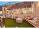 Outdoor entertaining area with a modern fire pit, comfortable seating, and landscaped surroundings at 11912 Skyline Arch Ct, Las Vegas, NV 89138