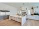Bright kitchen features a large island, stainless steel appliances, and white cabinetry at 11912 Skyline Arch Ct, Las Vegas, NV 89138