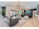 Spacious living area with a modern chandelier, fireplace, and seamless access to the outdoor patio at 11912 Skyline Arch Ct, Las Vegas, NV 89138