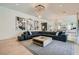 Bright living room with modern decor, large sectional sofa, and an open layout perfect for entertaining at 11912 Skyline Arch Ct, Las Vegas, NV 89138