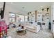 Bright living room with modern decor, large windows, and a comfortable couch at 11912 Skyline Arch Ct, Las Vegas, NV 89138