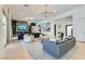 Spacious living room with hardwood floors, modern lighting fixtures, and a seamless connection to the outdoors at 11912 Skyline Arch Ct, Las Vegas, NV 89138