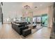 Bright, open-concept living room with modern furnishings and a view of the outdoor patio at 11912 Skyline Arch Ct, Las Vegas, NV 89138