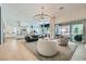 Open-concept living area featuring modern furnishings, hardwood floors, and natural light, connecting seamlessly to the kitchen at 11912 Skyline Arch Ct, Las Vegas, NV 89138