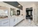 Beautiful main bathroom with a walk-in shower, dual sinks, and view to main bedroom at 11912 Skyline Arch Ct, Las Vegas, NV 89138