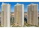 Three high-rise condo buildings featuring a modern design with reflective glass windows and resort style amenities at 135 E Harmon Ave # 3816, Las Vegas, NV 89109