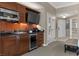 Cozy kitchenette featuring wood cabinetry, mini-fridge, microwave, and sleek black countertops at 135 E Harmon Ave # 3816, Las Vegas, NV 89109