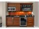 Kitchenette features wood cabinets, stainless steel appliances, and granite countertops at 135 E Harmon Ave # 3816, Las Vegas, NV 89109