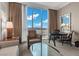 A cozy sitting area in a room with a large window offering views of the Las Vegas valley at 135 E Harmon Ave # 3816, Las Vegas, NV 89109