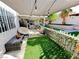 Charming backyard patio featuring stylish seating, artificial turf, and string lights at 1505 Lilac Breeze Cir, Las Vegas, NV 89108