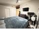 Spacious bedroom with ample closet space, modern bed, and dark wood-look floors at 1505 Lilac Breeze Cir, Las Vegas, NV 89108
