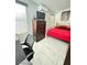 Comfortable bedroom featuring natural light, a full bed, dresser, and a sleek workspace at 1505 Lilac Breeze Cir, Las Vegas, NV 89108