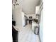 Open-concept kitchen and dining area with bright white cabinetry and stainless appliances at 1505 Lilac Breeze Cir, Las Vegas, NV 89108