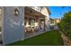 An outdoor patio area features comfortable seating, a ceiling fan and a view of the beautifully landscaped yard at 1869 Bronze Patina St, Henderson, NV 89044