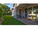 Inviting back patio with covered seating area and manicured lawn, ideal for outdoor entertaining at 1869 Bronze Patina St, Henderson, NV 89044