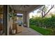 Covered patio with furniture, providing a comfortable outdoor living space with a view of the garden and lawn at 1869 Bronze Patina St, Henderson, NV 89044