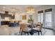 Bright dining area featuring a round table with seating for four near the kitchen and double glass doors to the patio at 1869 Bronze Patina St, Henderson, NV 89044