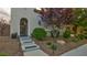 Beautifully landscaped front yard with stone accents and an arched entryway, adding to the home's charm at 1869 Bronze Patina St, Henderson, NV 89044