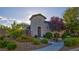 Charming single-story home with arched entry and well-manicured landscaping with blooming flowers at 1869 Bronze Patina St, Henderson, NV 89044