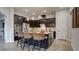 Modern kitchen with dark cabinets, stainless steel appliances, and large island with bar seating at 1869 Bronze Patina St, Henderson, NV 89044