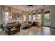 Cozy living room with comfortable sofas, decorative mirrors, and plenty of natural light, creating a warm and inviting atmosphere at 1869 Bronze Patina St, Henderson, NV 89044