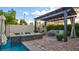 Relaxing poolside retreat with covered pergola, stylish furniture, and water feature for serene enjoyment at 1869 Bronze Patina St, Henderson, NV 89044
