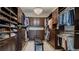 Spacious walk-in closet with custom shelving, drawers, and ample storage for clothing and accessories at 1869 Bronze Patina St, Henderson, NV 89044