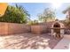Backyard with brick pizza oven and landscaping at 2143 Vista Famosa Ct, Las Vegas, NV 89123