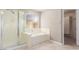 Bathroom with separate tub and shower in neutral color palette, with tile floor at 2143 Vista Famosa Ct, Las Vegas, NV 89123