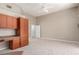 Bright bedroom features neutral carpet, ceiling fan, and built in desk and storage unit at 2143 Vista Famosa Ct, Las Vegas, NV 89123