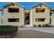 Exterior view of building featuring two-story apartments with balconies, stucco walls, and tile roofs at 2451 N Rainbow Blvd # 2076, Las Vegas, NV 89108