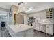 Modern kitchen with white cabinets, stainless appliances, updated lighting and a beautiful backsplash at 2451 N Rainbow Blvd # 2076, Las Vegas, NV 89108