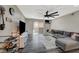 Inviting living room with plank floors, a large fan, and a sliding glass door that brings in natural light at 2451 N Rainbow Blvd # 2076, Las Vegas, NV 89108
