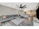 Open living room featuring grey walls and a large sectional sofa that flows into the dining and kitchen area at 2451 N Rainbow Blvd # 2076, Las Vegas, NV 89108