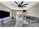Spacious living room with plank floors, a large fan, modern media center and sliding doors to a private patio at 2451 N Rainbow Blvd # 2076, Las Vegas, NV 89108