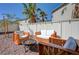 Comfortable backyard lounge area with a fire pit, surrounded by mature trees and a privacy fence at 2586 Begonia Valley Ave, Henderson, NV 89074