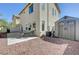 Well-maintained backyard featuring a concrete patio, storage shed, and low-maintenance gravel landscaping at 2586 Begonia Valley Ave, Henderson, NV 89074