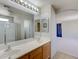 Bathroom features double sinks, a large mirror, and walk in shower at 2586 Begonia Valley Ave, Henderson, NV 89074
