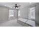 Well-lit bedroom featuring carpeted floors, ceiling fan, and bright natural light at 2586 Begonia Valley Ave, Henderson, NV 89074