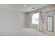 Bedroom featuring plush carpeting, neutral walls, a window with white curtains, and a wall decor at 2586 Begonia Valley Ave, Henderson, NV 89074