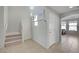 Neutral entryway with tiled floor leads to staircase and sunlit living space at 2586 Begonia Valley Ave, Henderson, NV 89074
