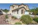 Landscaped front yard with beautiful stone elements and desert flora leading to this charming two-story home at 2586 Begonia Valley Ave, Henderson, NV 89074