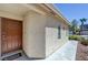 View of the front door with a well maintained side yard and desert landscaping at 2586 Begonia Valley Ave, Henderson, NV 89074