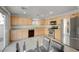 Well-lit kitchen features wooden cabinets and stainless steel appliances at 2586 Begonia Valley Ave, Henderson, NV 89074